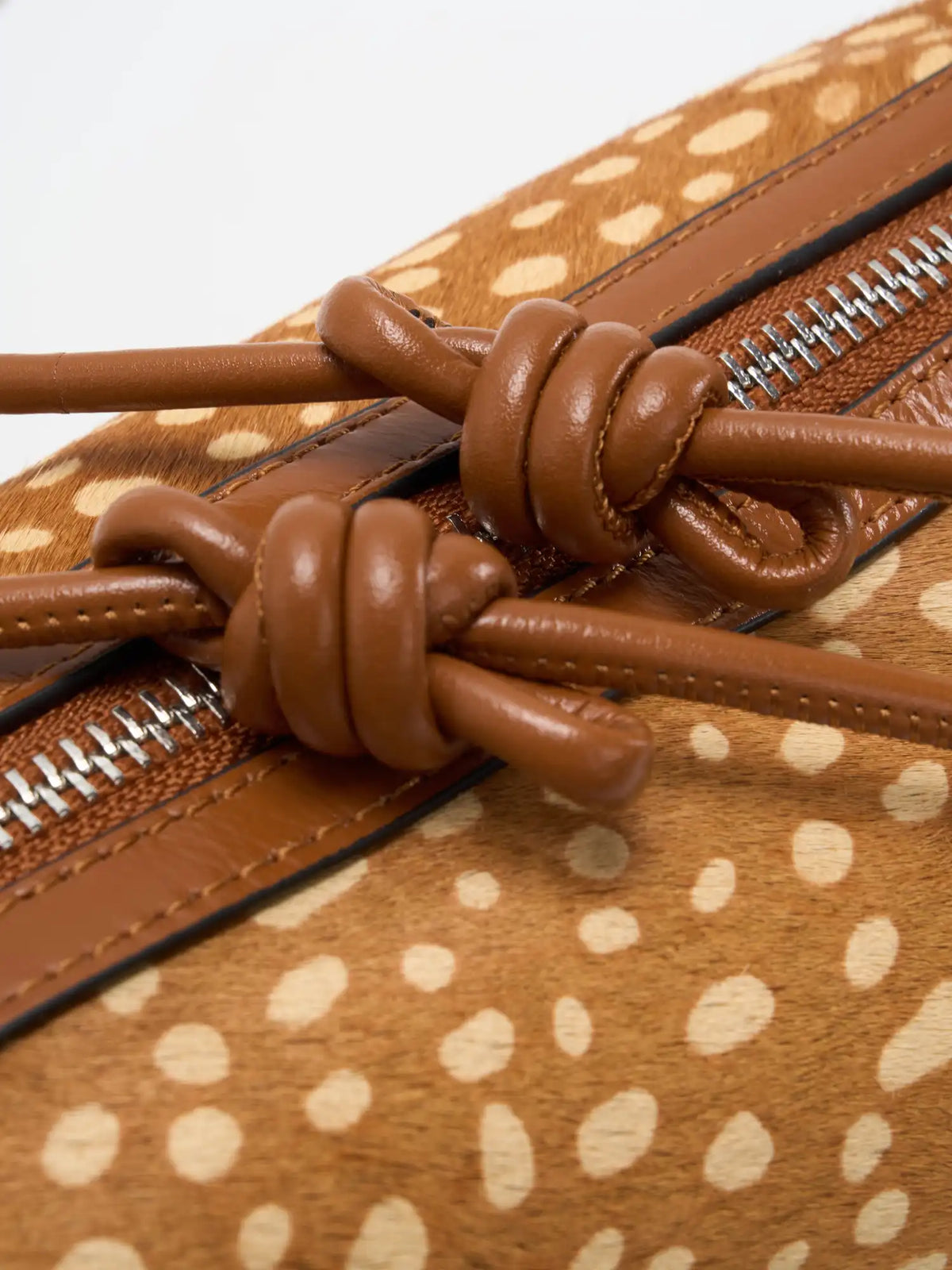 Close-up of knotted top-grain cowhide crossbody strap details
