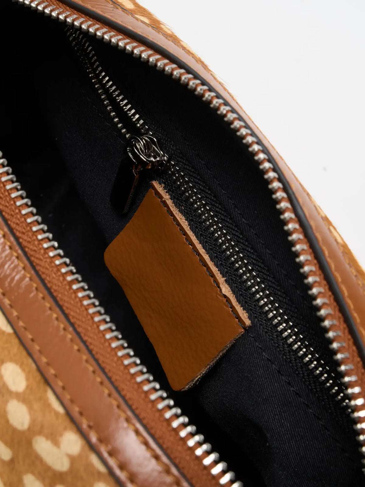 Close-up of interior zip pocket and black fabric lining