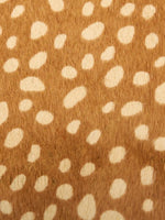 Close-up of cream spots on warm brown hair-on hide