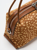 Close-up of side profile, zipper, handle and silver-tone ring