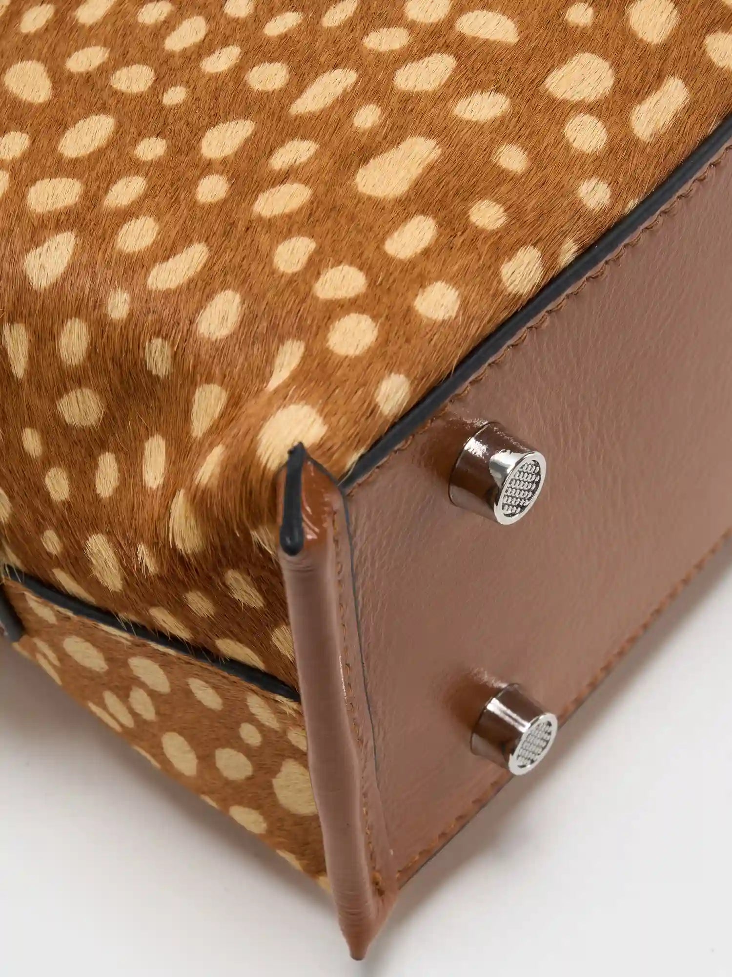 Top-grain cowhide base and metal feet detail