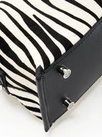 Close-up of black top-grain cowhide base and silver-tone feet