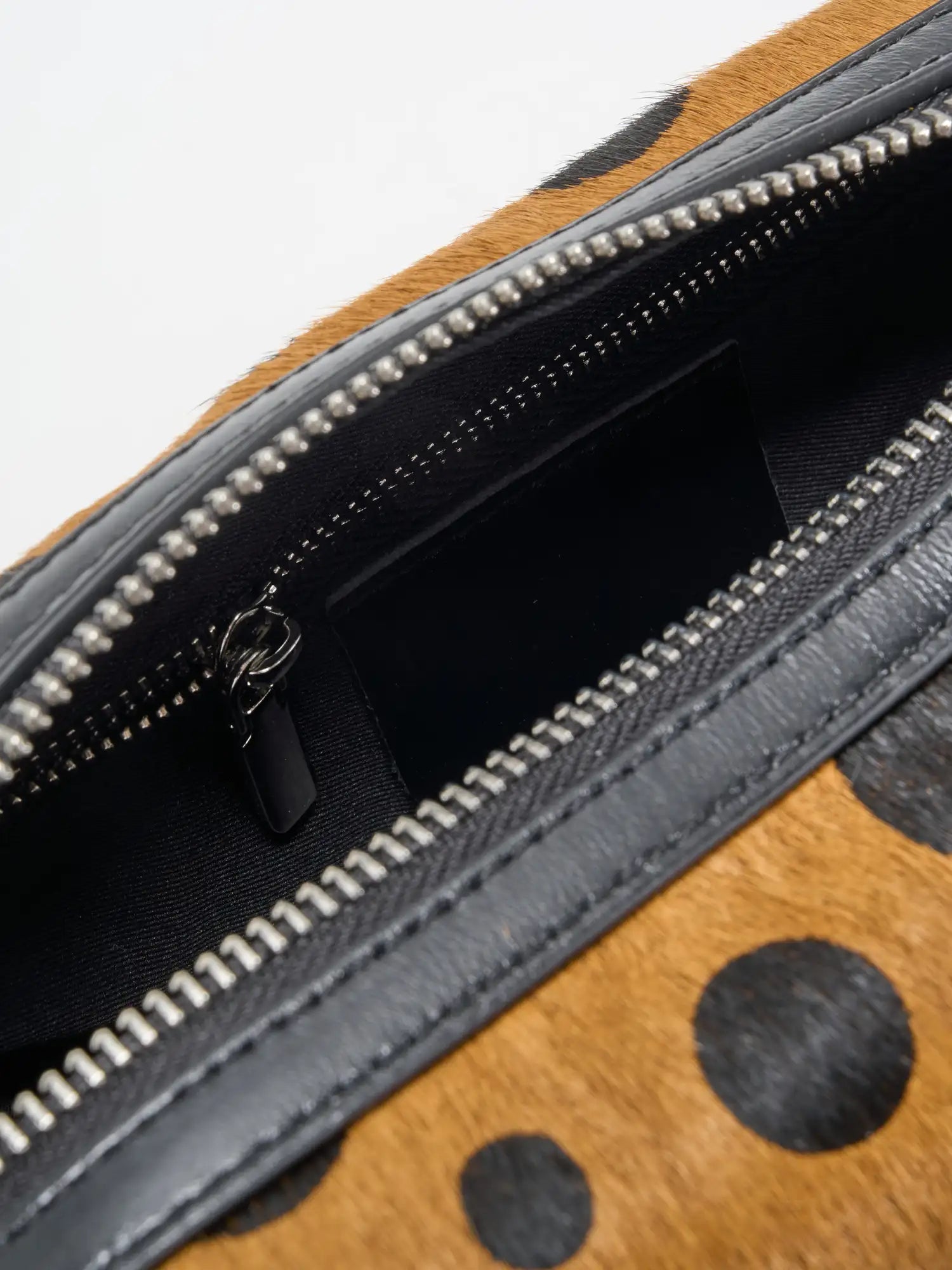 Close-up of black fabric interior and zip pocket