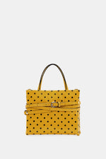 Small glossy yellow polka-dot square bag front view with strap wrapped around the body