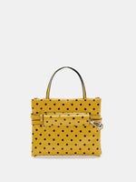 Small yellow polka-dot square bag rear view with strap stored around the bag