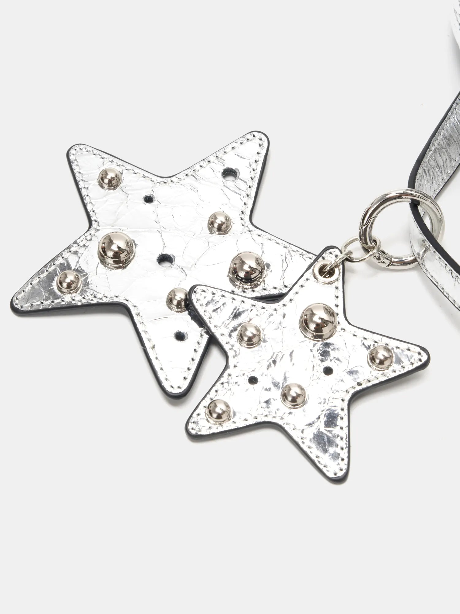 Layered metallic studded star charms close-up
