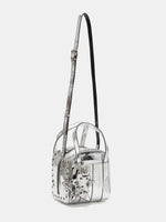 Metallic silver grommet cube bag shown with adjustable crossbody strap