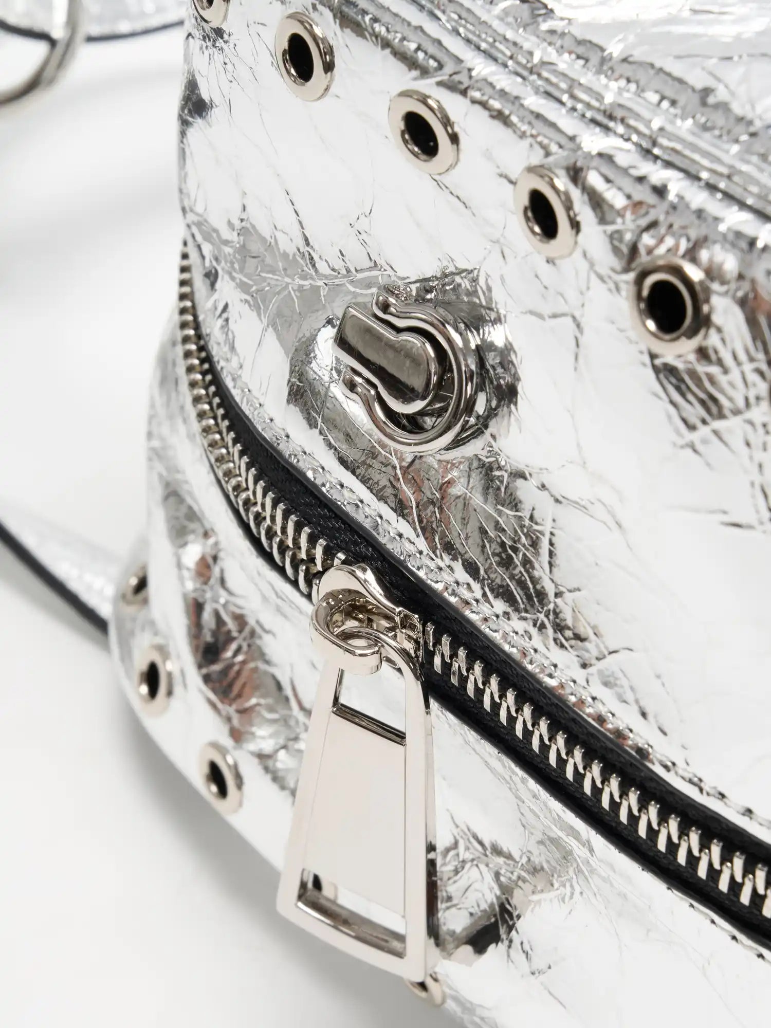 Silver-tone zipper pull and side grommet detail close-up