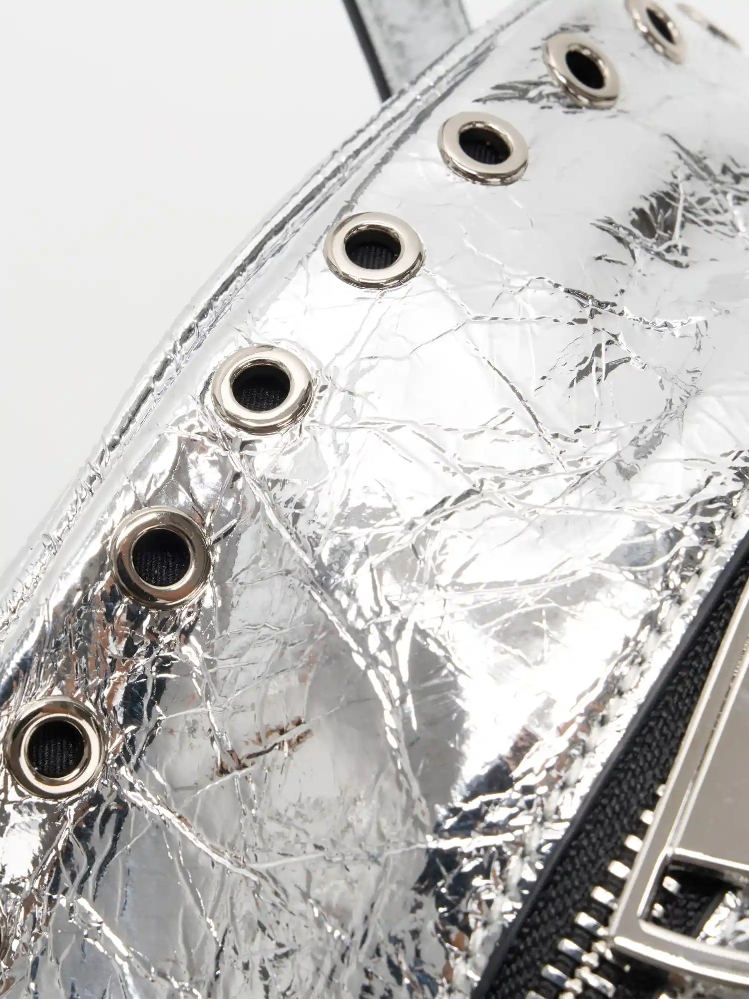 Hollow silver-tone grommets along the cube bag opening
