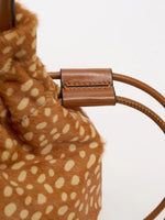 Brown stitched drawstring keeper beside the fawn-spotted hair-on bag body