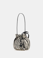Ivory and black zebra-print rounded drawstring shoulder bag with twin spherical cord ends