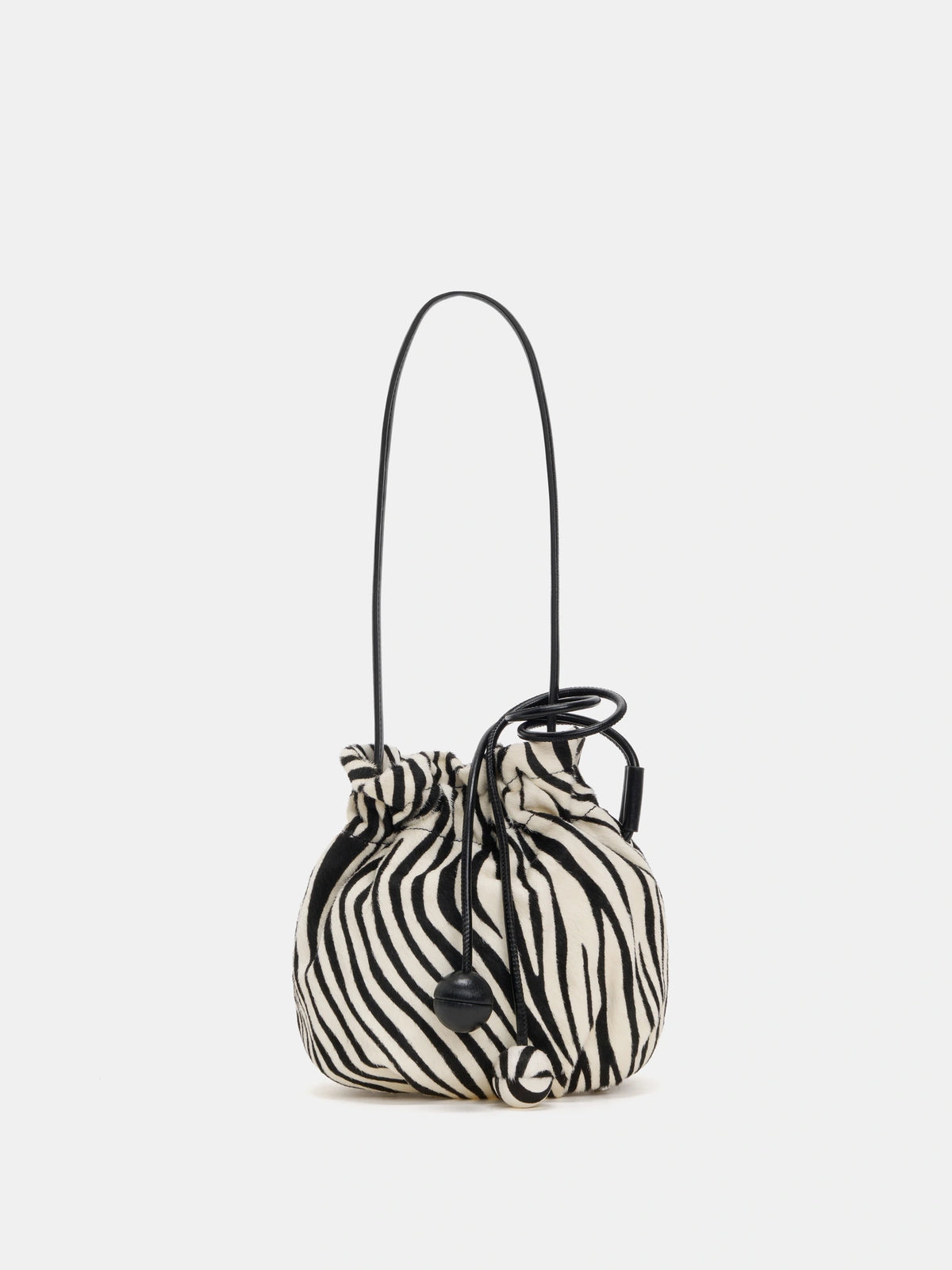 Ivory and black zebra-print rounded drawstring shoulder bag with twin spherical cord ends