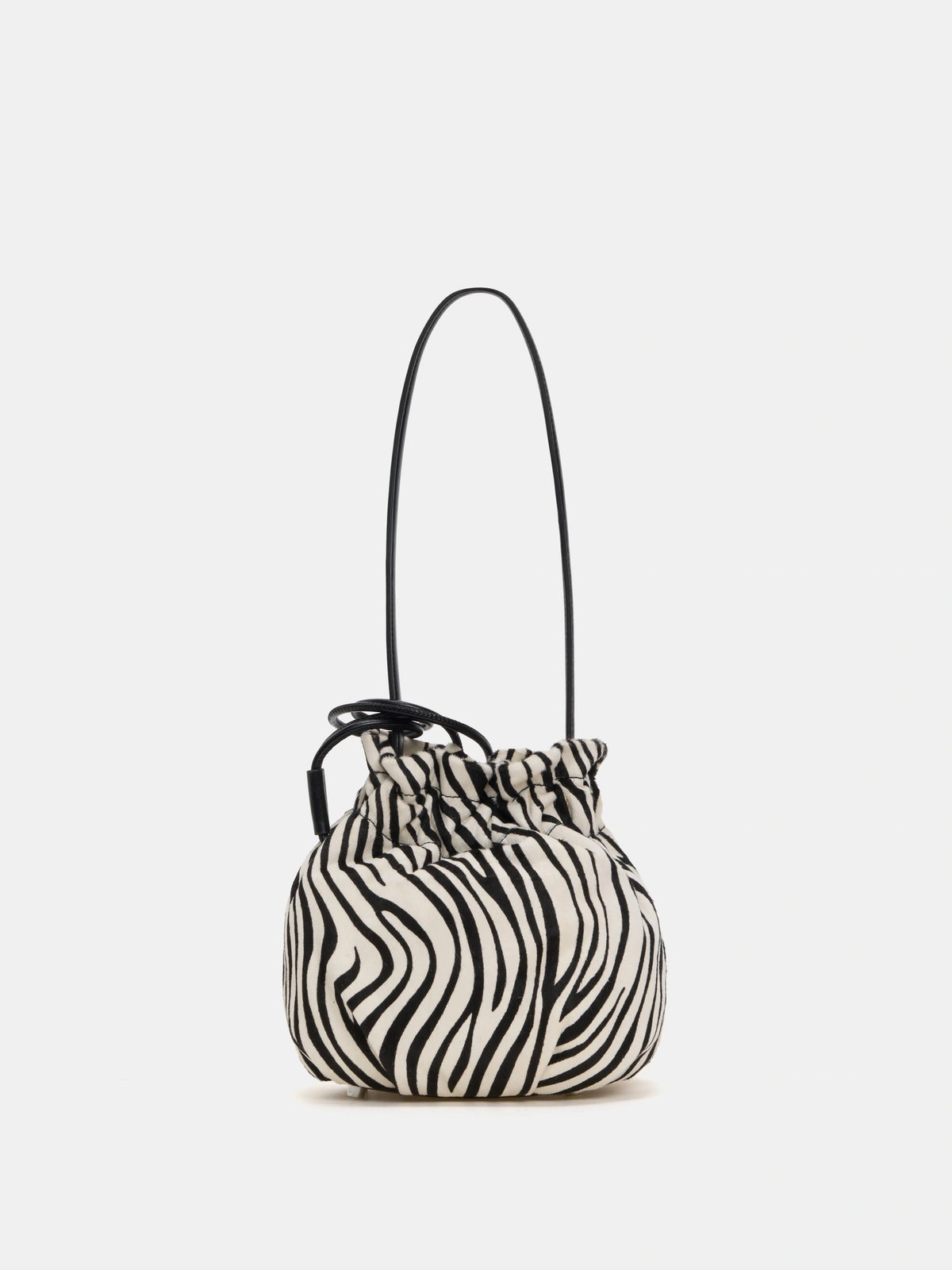 Back view of ivory zebra-print shoulder bag showing curved panels and gathered top