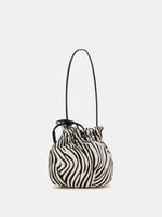 Back view of ivory zebra-print shoulder bag showing curved panels and gathered top