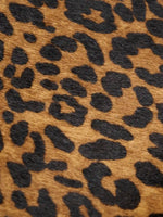 Warm tan and black leopard hair-on hide texture close-up