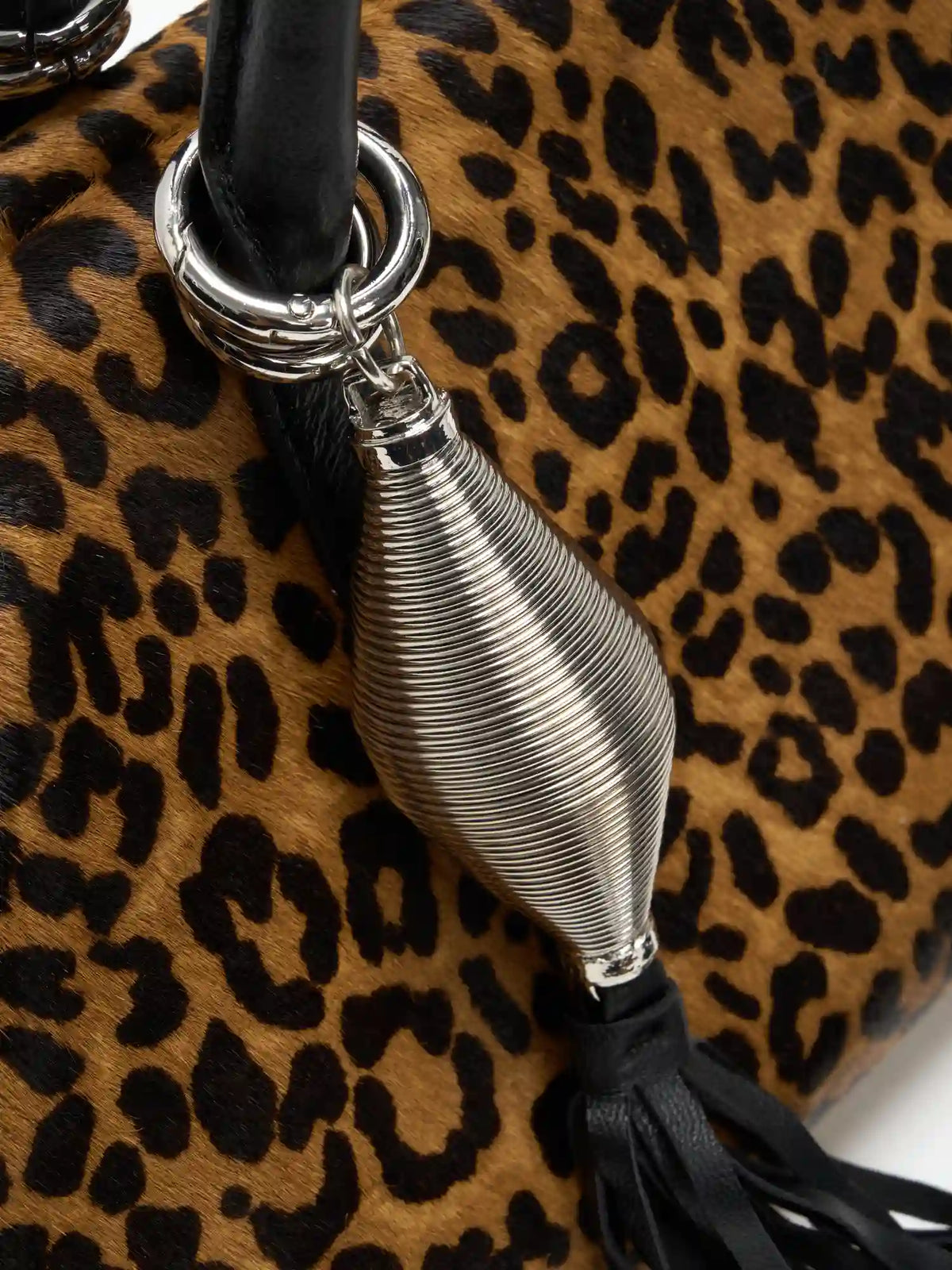 Bright silver sculptural tassel charm on leopard hair-on hide