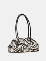 Zebra hair-on frame bag three-quarter front view with long handles
