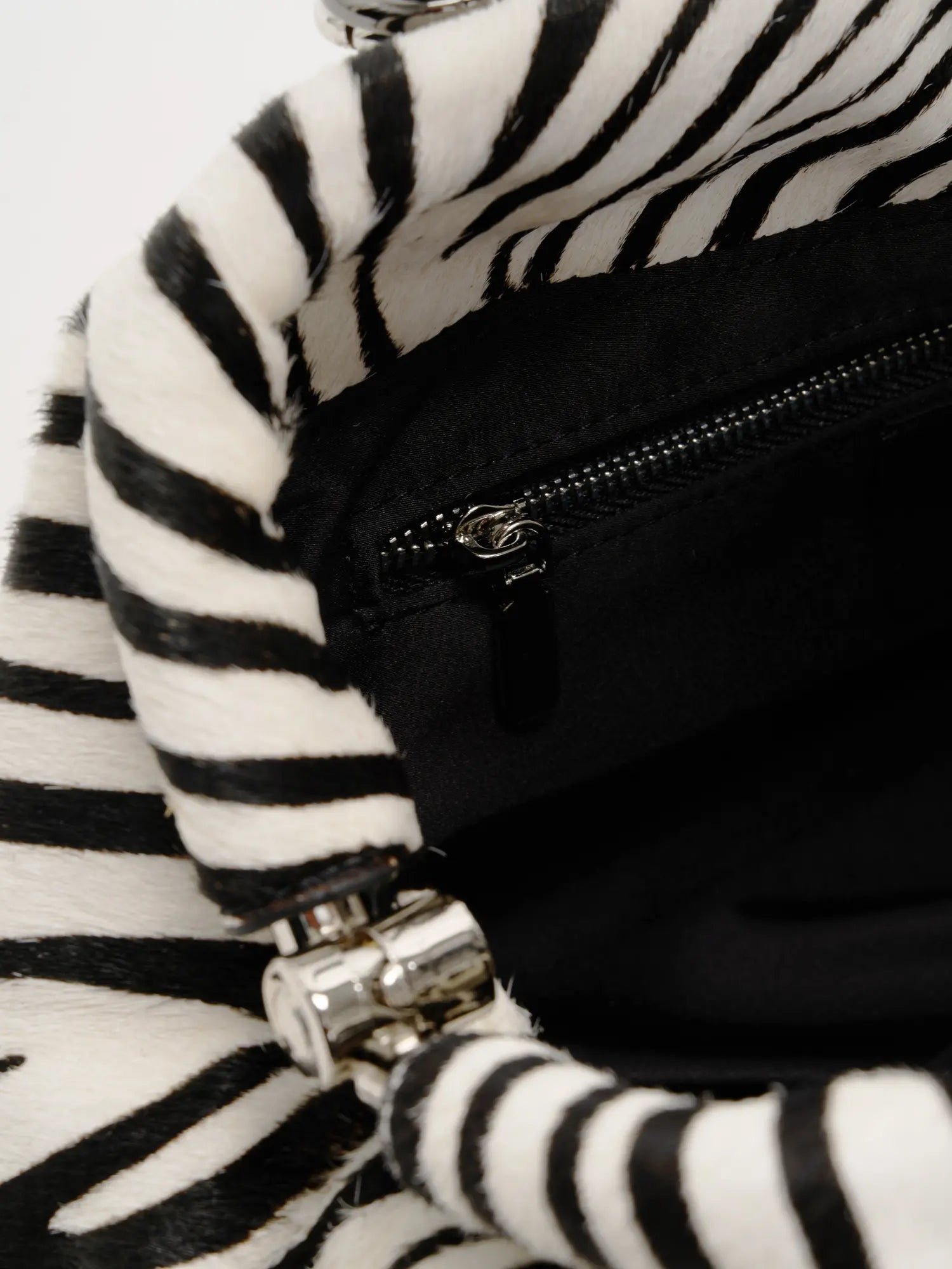 Interior zip pocket inside the zebra hair-on shoulder bag