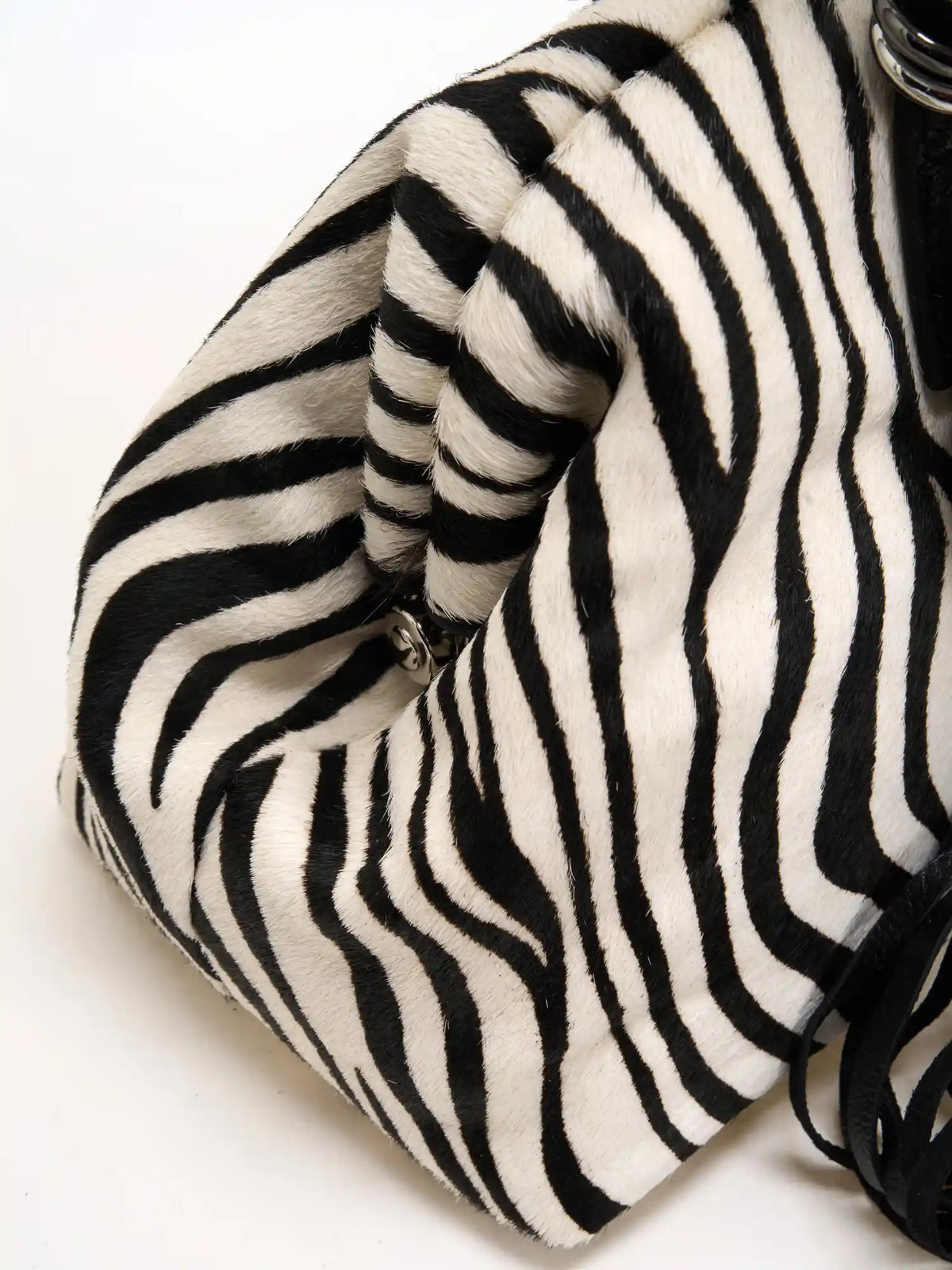 Sculpted side fold on the zebra hair-on frame bag
