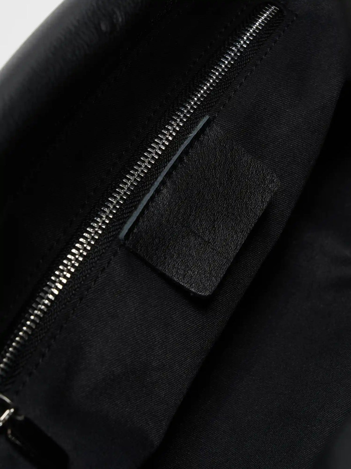 Interior slip pocket inside the black leather shoulder bag