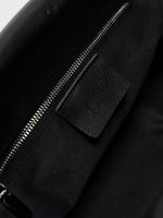 Interior slip pocket inside the black leather shoulder bag