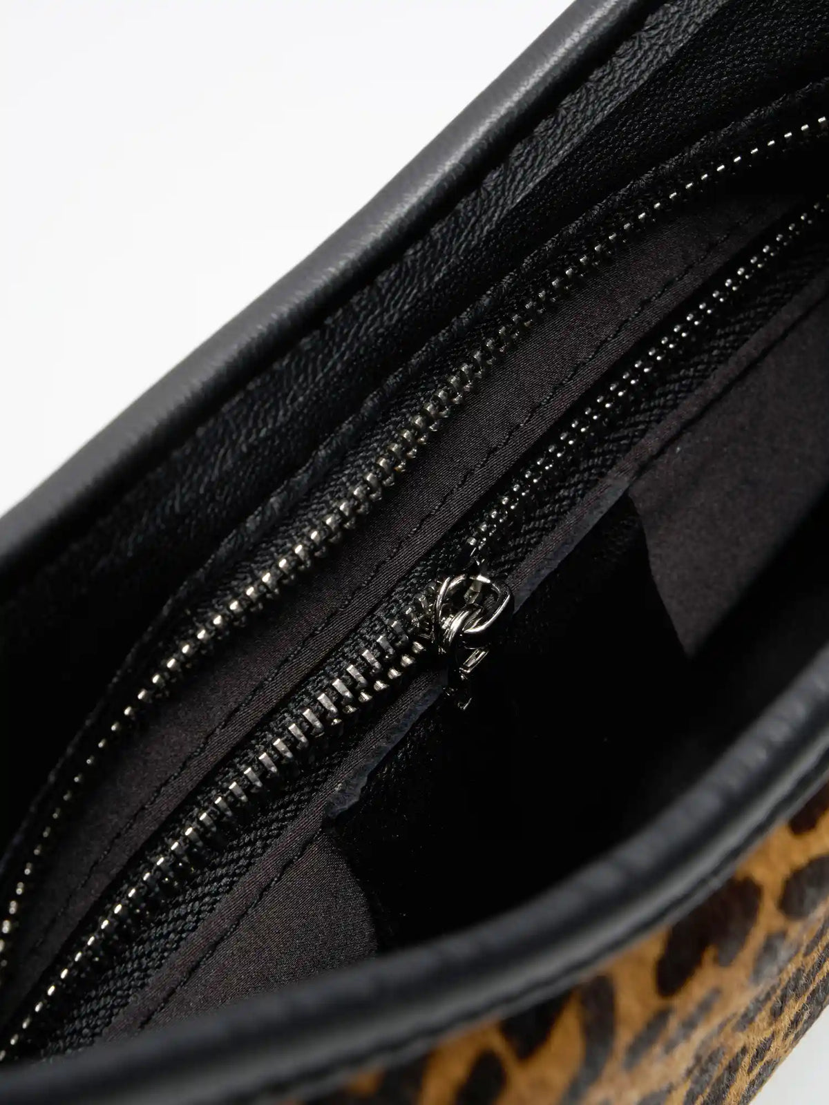 interior zip pocket detail of The Arc Crescent Bag - Leopard