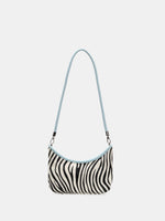 Front view of an Ice Zebra hair-on hide crescent bag with ice-blue trim and a short shoulder strap