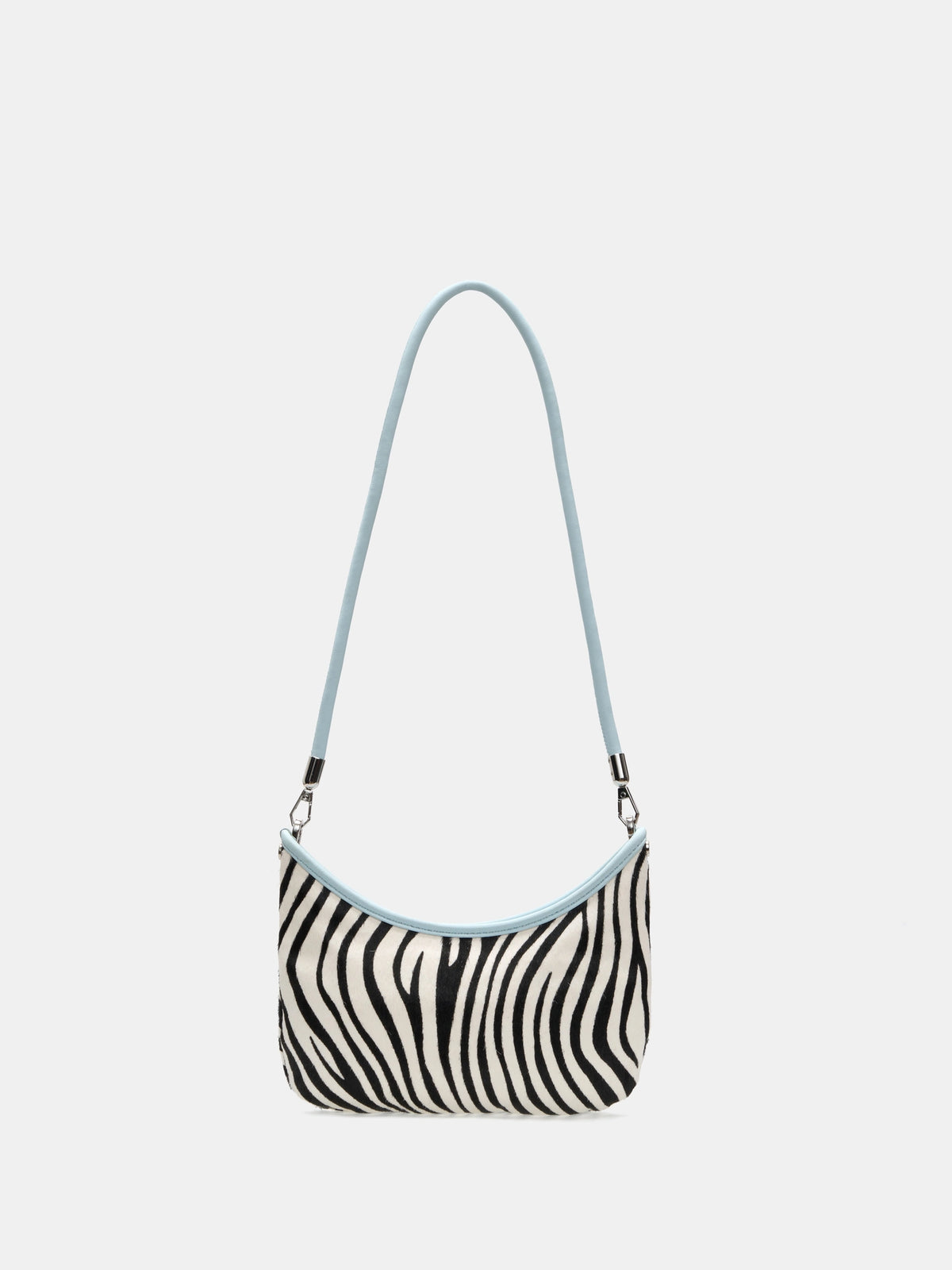 Front view of an Ice Zebra hair-on hide crescent bag with ice-blue trim and a short shoulder strap