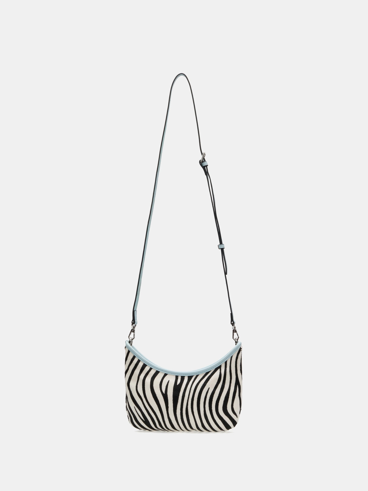 Ice Zebra crescent bag shown with the adjustable long strap attached
