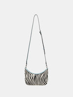 Ice Zebra crescent bag shown with the adjustable long strap attached