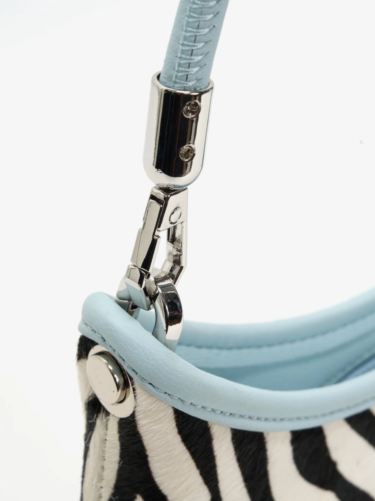 Close-up of the short ice-blue strap, metal clasp, and round side hardware