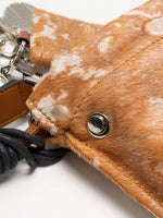 Top edge, round silver-tone fitting, and knotted cord of Gilded Caramel bag