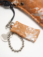 Reverse side of matching Gilded Caramel pouch with rings and silver-tone accessories
