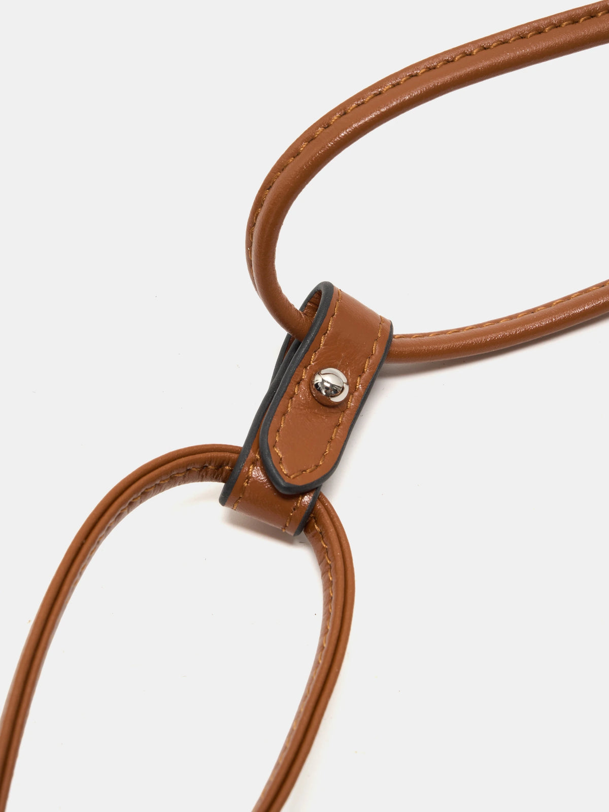 Brown rounded handle and stitched leather connector on Gilded Caramel bucket bag