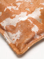 Bottom corner seam and patterned hair-on surface of Gilded Caramel bucket bag
