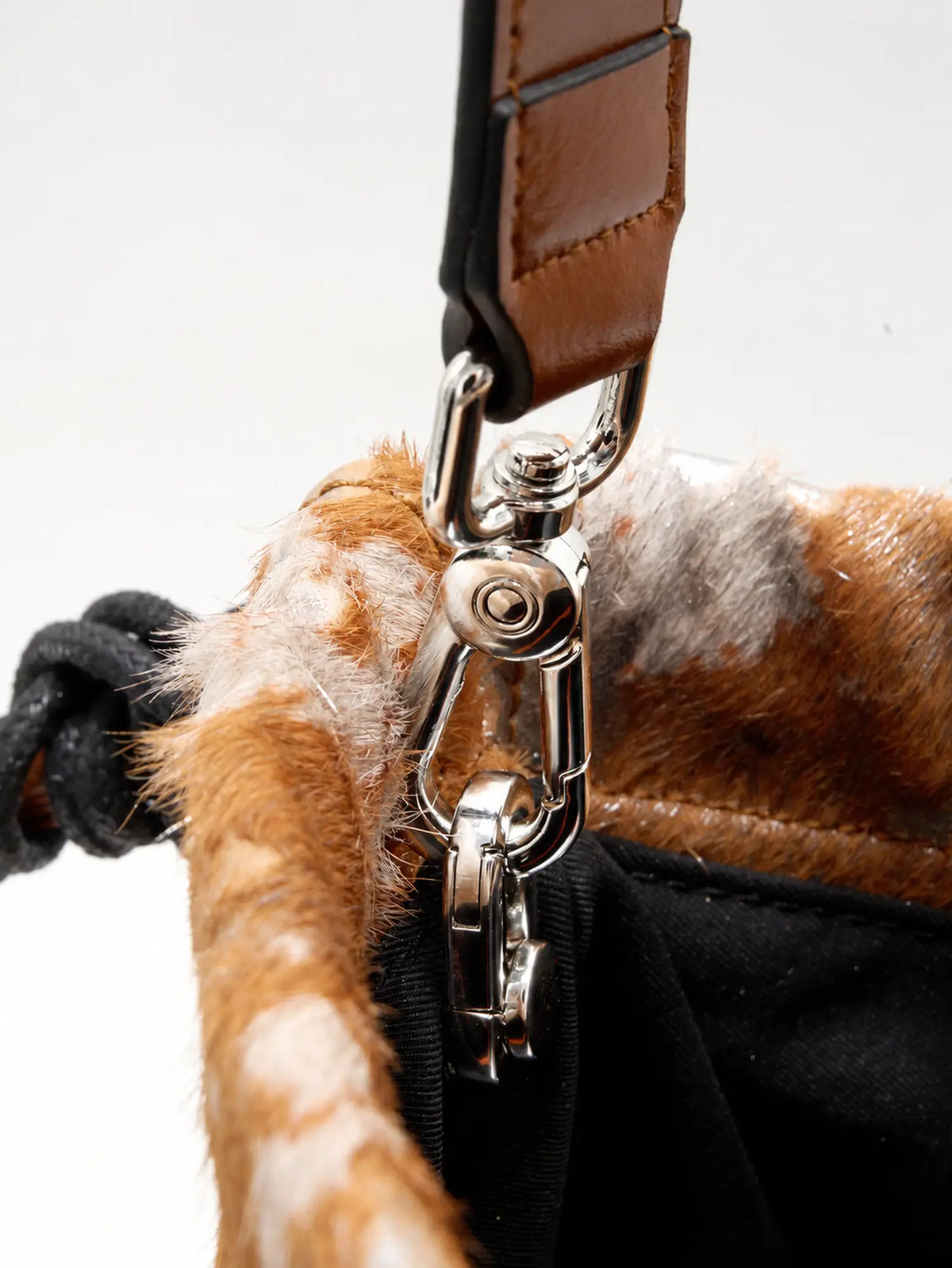 polished contrast detail of The Painted Charm Slim Bucket Bag - Gilded Caramel