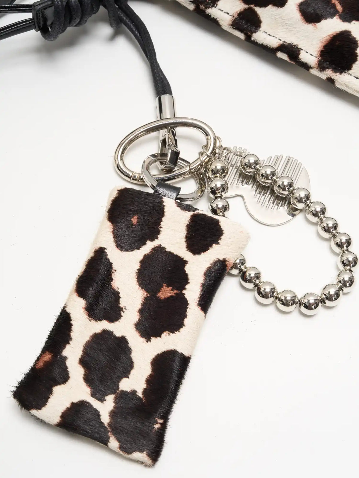 print meets shine detail of The Painted Charm Slim Bucket Bag - Light Beige Leopard