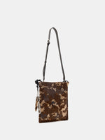 Mocha Cow Print bucket bag with adjustable dark brown leather long strap attached