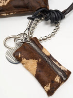 Mocha Cow Print zip pouch, silver-tone bead loop, and black knotted cord