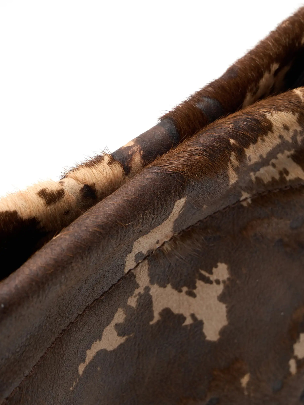 Close-up of Mocha Cow Print top edge showing brown and beige hair-on texture
