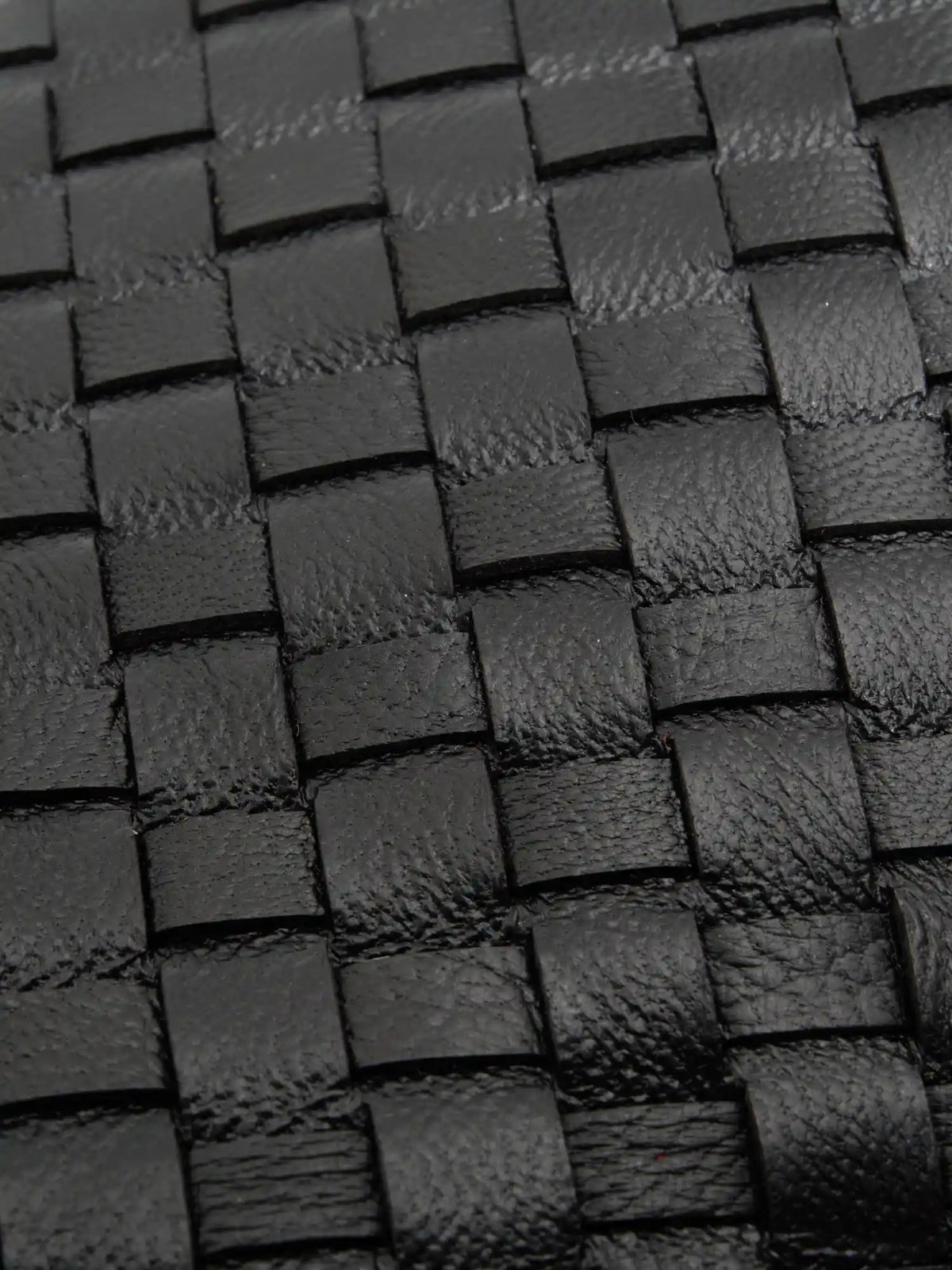 Black Weave handwoven sheepskin chain baguette bag close-up of the handwoven sheepskin strips