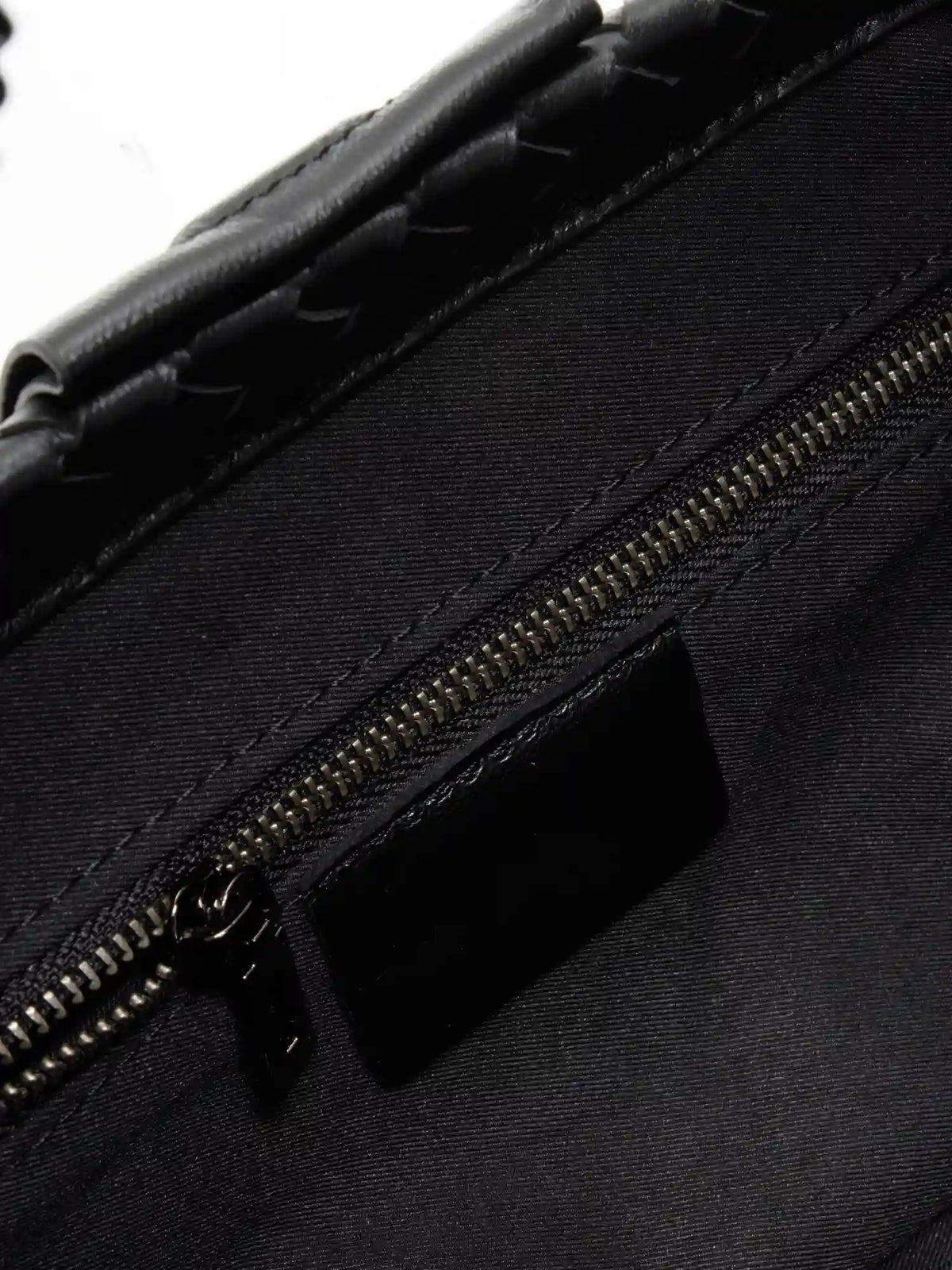 Black Weave handwoven sheepskin chain baguette bag close-up of the interior zip pocket