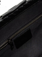 Black Weave handwoven sheepskin chain baguette bag close-up of the interior zip pocket