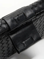 Black Weave handwoven sheepskin chain baguette bag close-up of the magnetic tab and woven top edge