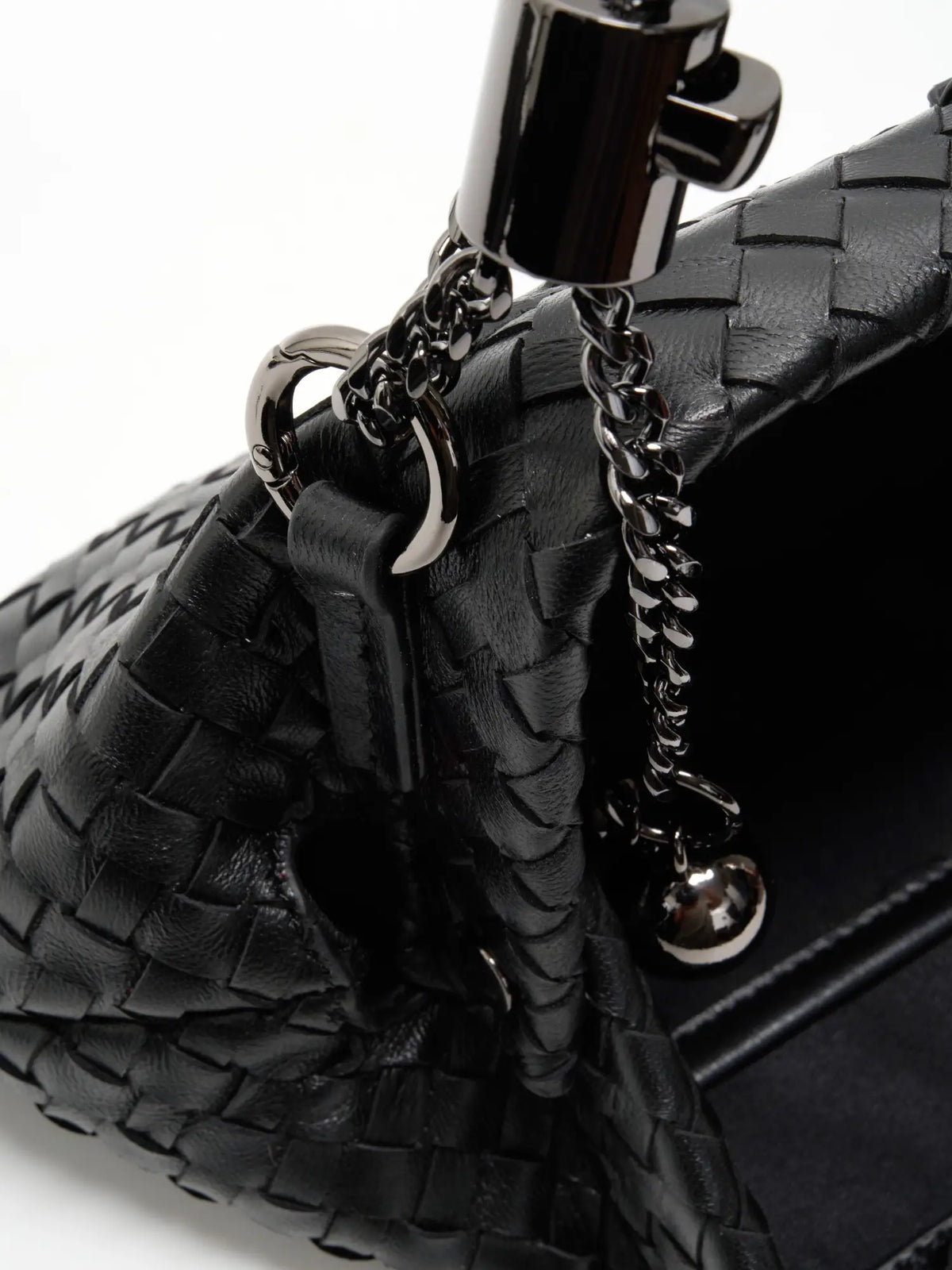 Black Weave handwoven sheepskin chain baguette bag close-up of the adjustable chain and spherical ends