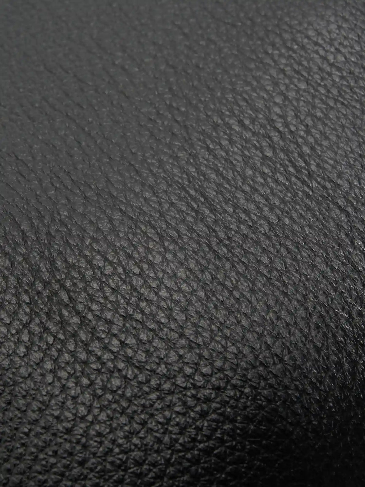 Pebbled Black cowhide chain baguette bag close-up of the fine pebbled cowhide texture