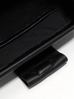 Pebbled Black cowhide chain baguette bag close-up of the interior slip pocket and magnetic tab