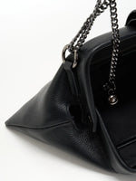Pebbled Black cowhide chain baguette bag close-up of the chain attachment and spherical ends