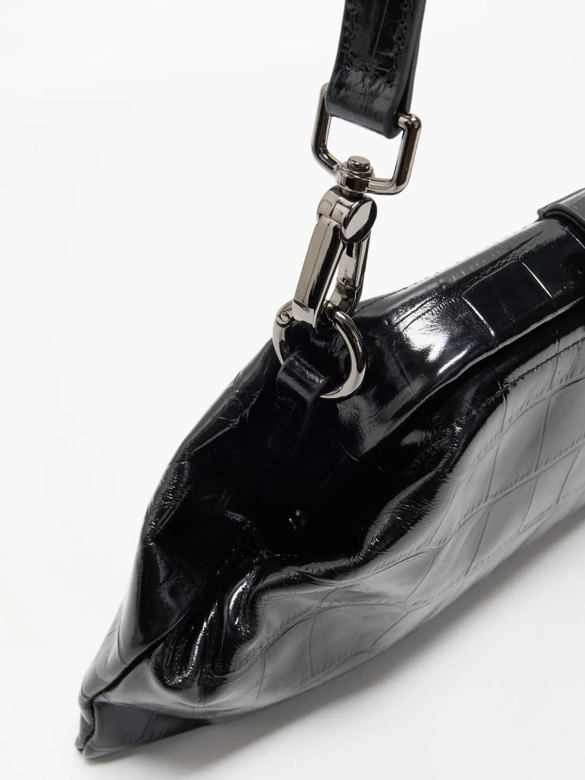 Black Croc cowhide chain baguette bag close-up of the detachable leather strap clip and folded side