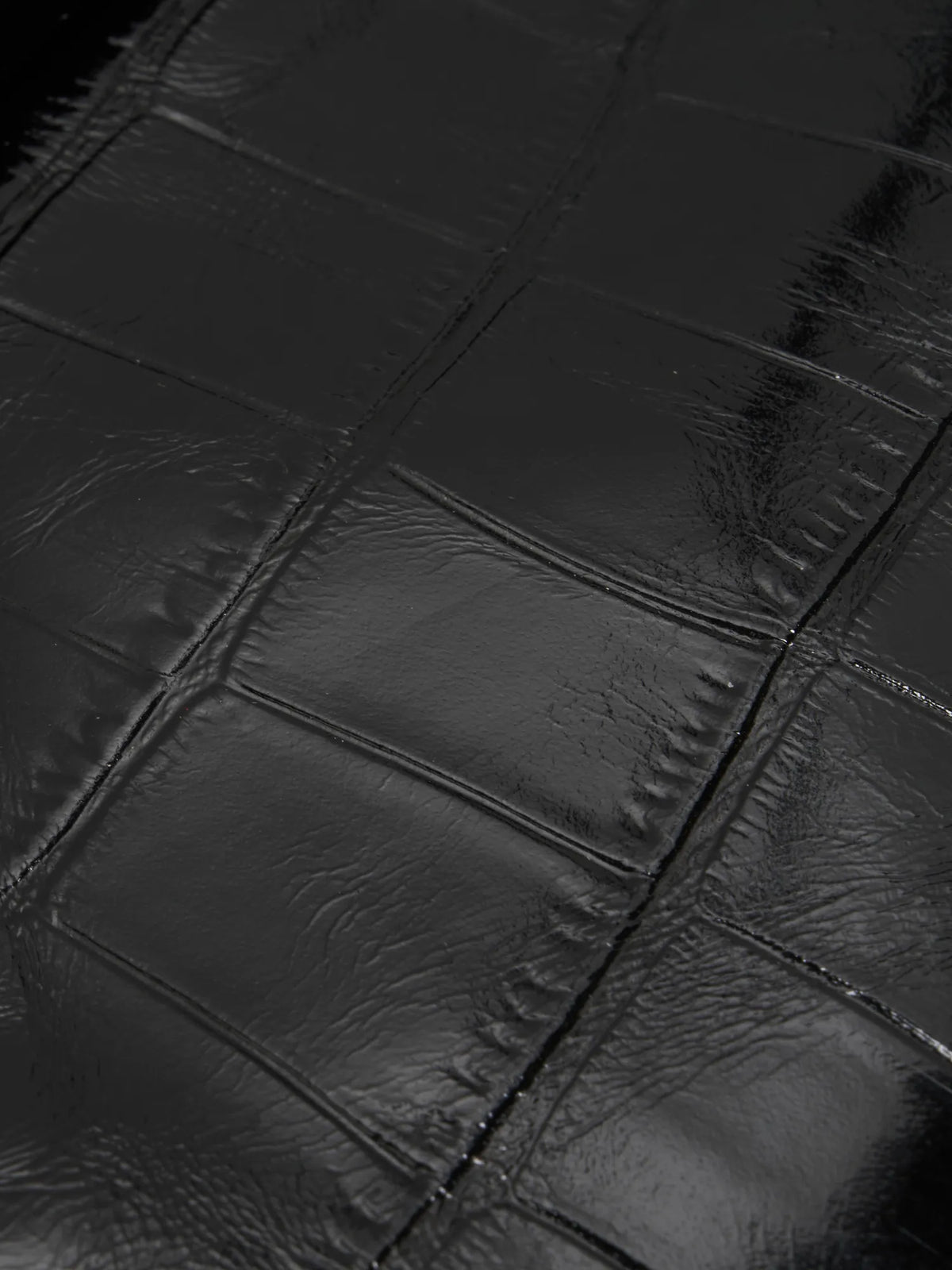 Black Croc cowhide chain baguette bag close-up of the glossy large-scale croc pattern